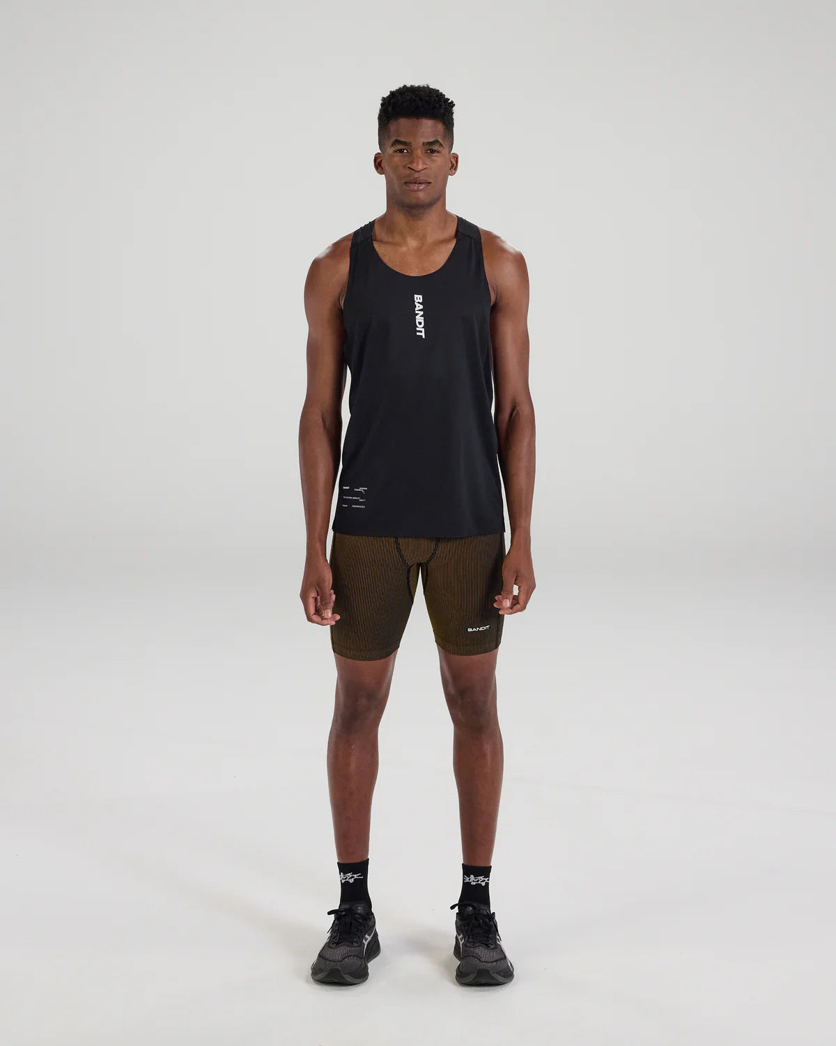 Bandit Running Striped Cadence™ 7 Pocket Half Tights - Black / Dijon